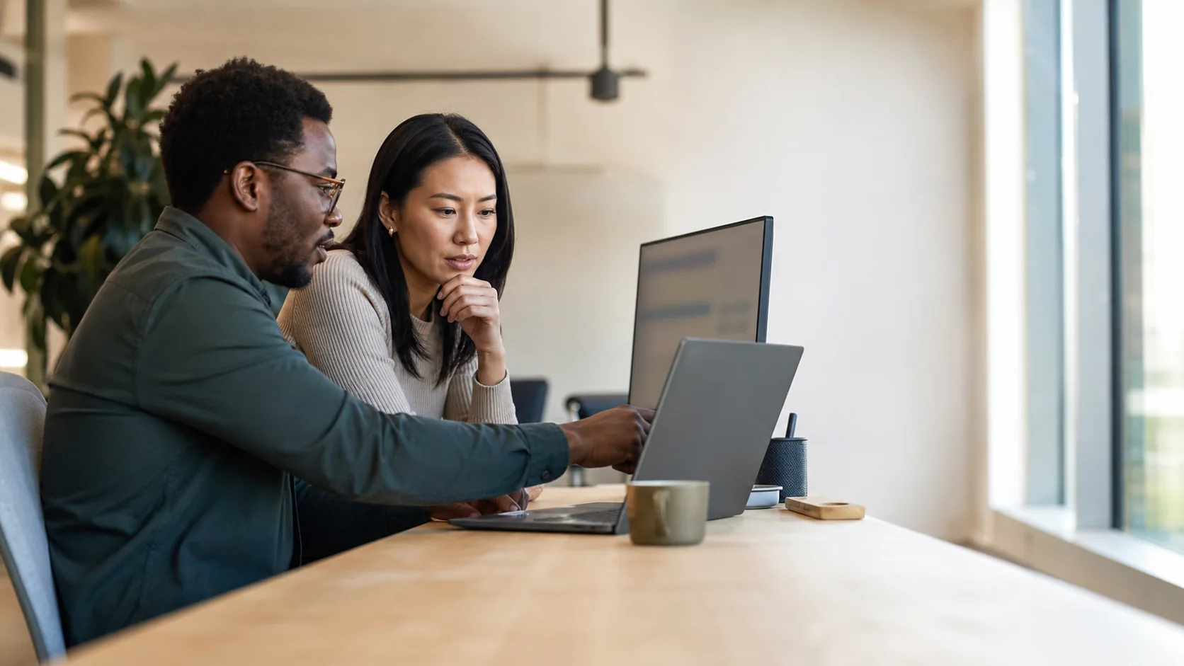 Two health-tech colleagues reviewing an integration release plan together